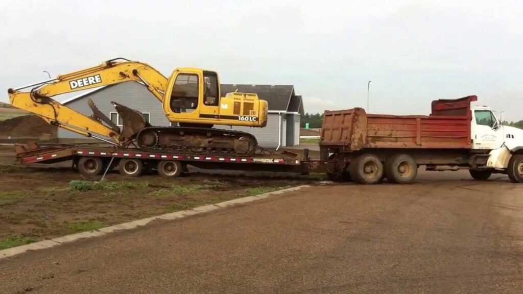 dump-truck-pulling-excavator